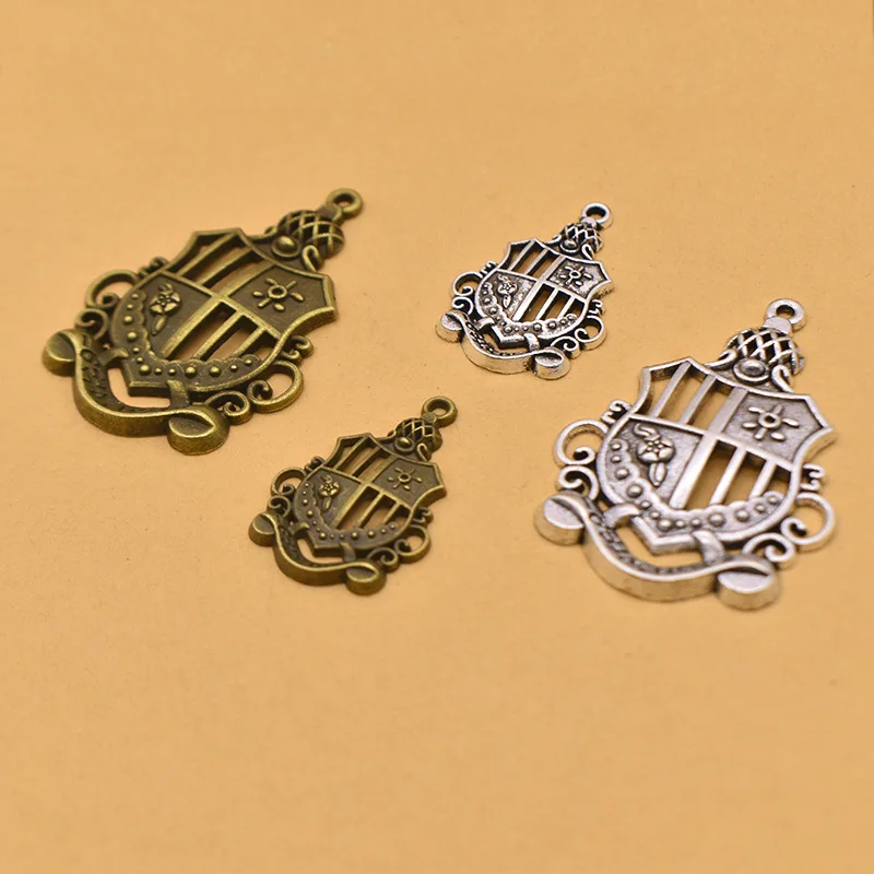 Unique and charming vintage style! Beautifully hollowed alloy crown pendant, badge, to complement your accessories!