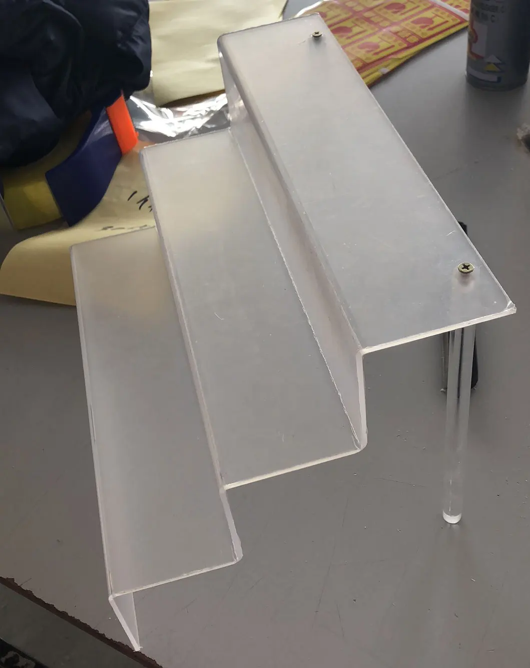 Acrylic Stair Step Display Stand for Cosmetic in Shopping Mall Customized Size Back Sticker Support