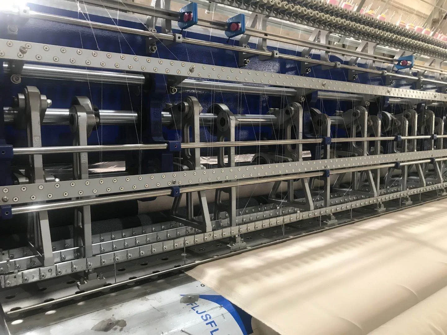 Computerized multi-needle lock stitch quilting machines for quilters