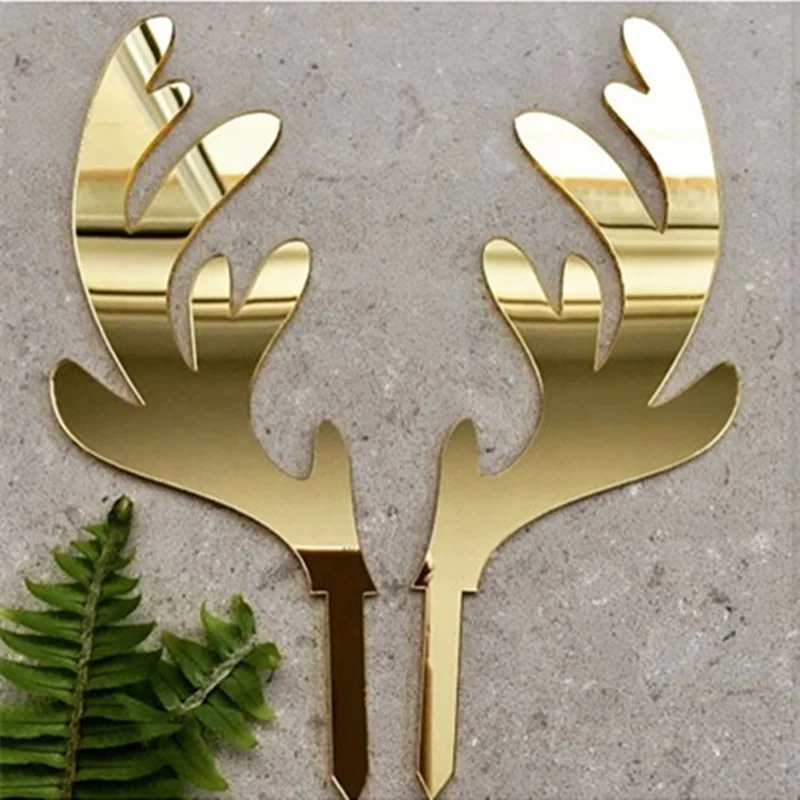 A pair of gold elk acrylic Christmas cake topper for cake decoration