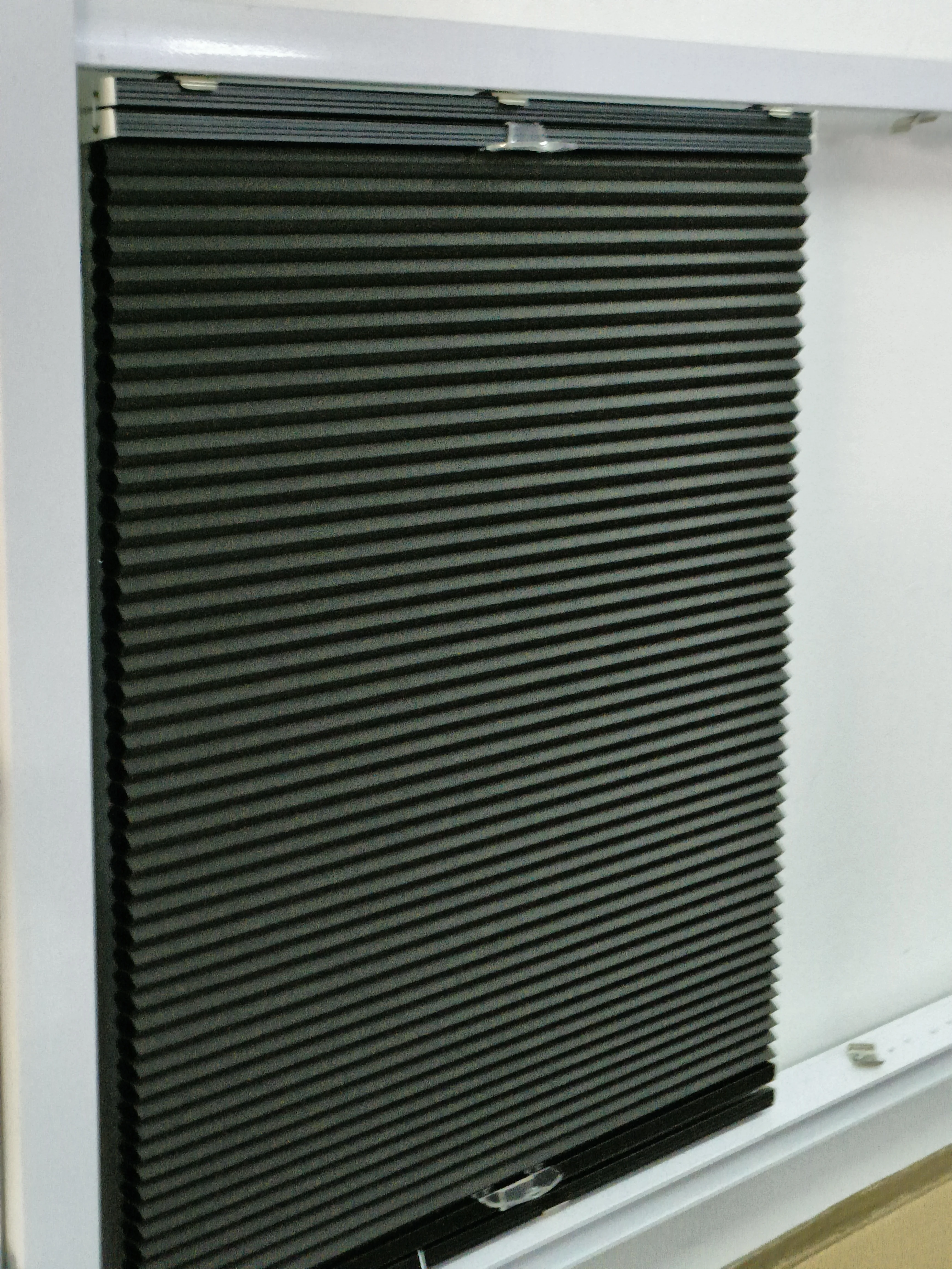 Cordless black color blackout cellular blind