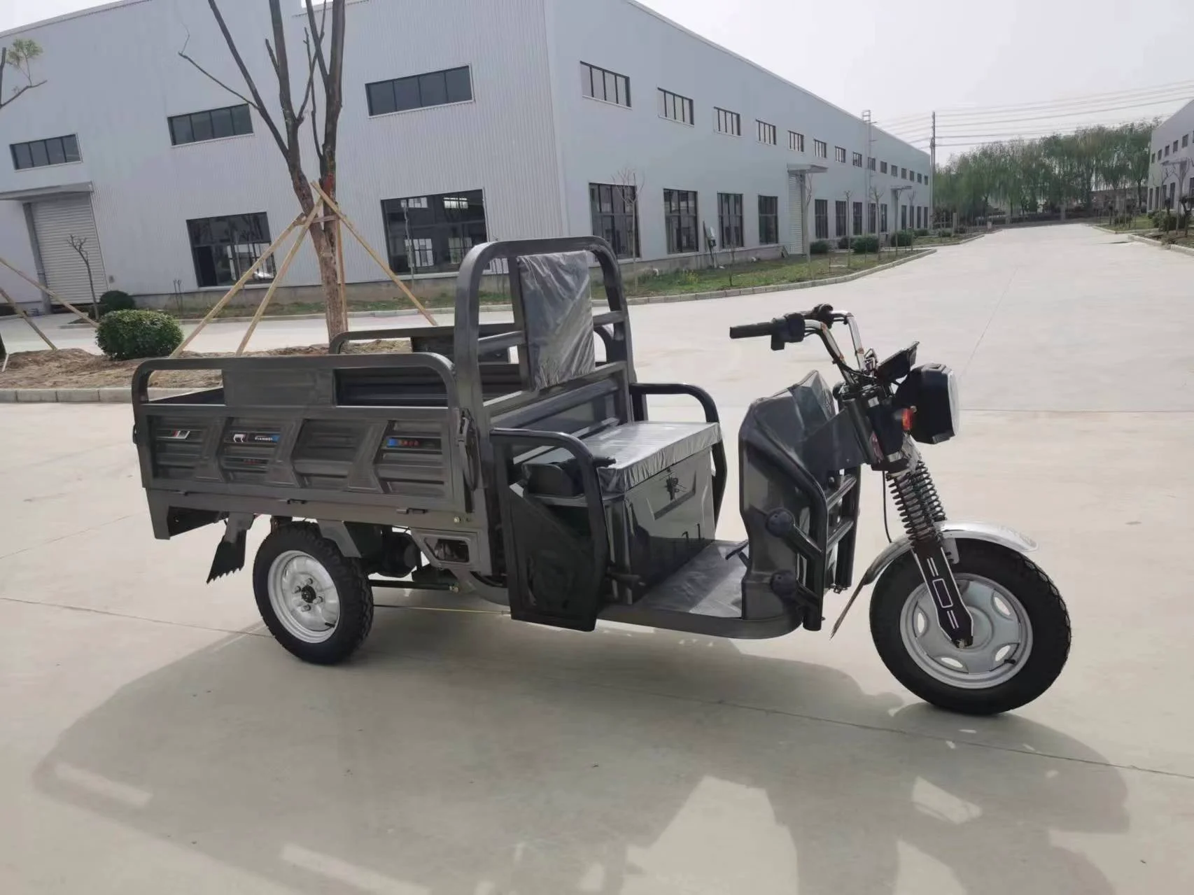 Two Chinese three wheeled electric freight vehicles electric tricycles tuk tuk tricycles delivery tricycles