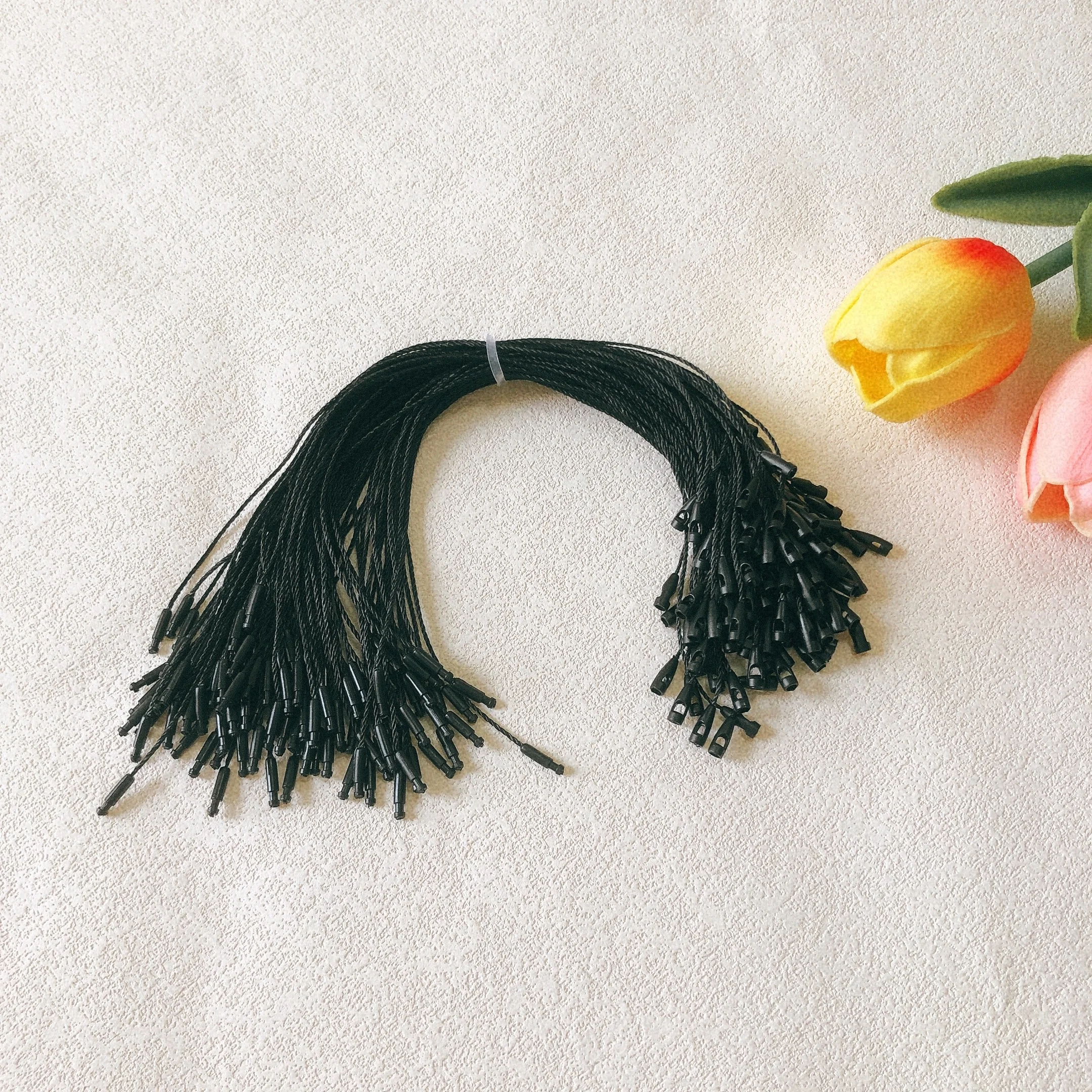 Clothing accessory polyester biodegradable hangtag BulletHead black string knotting