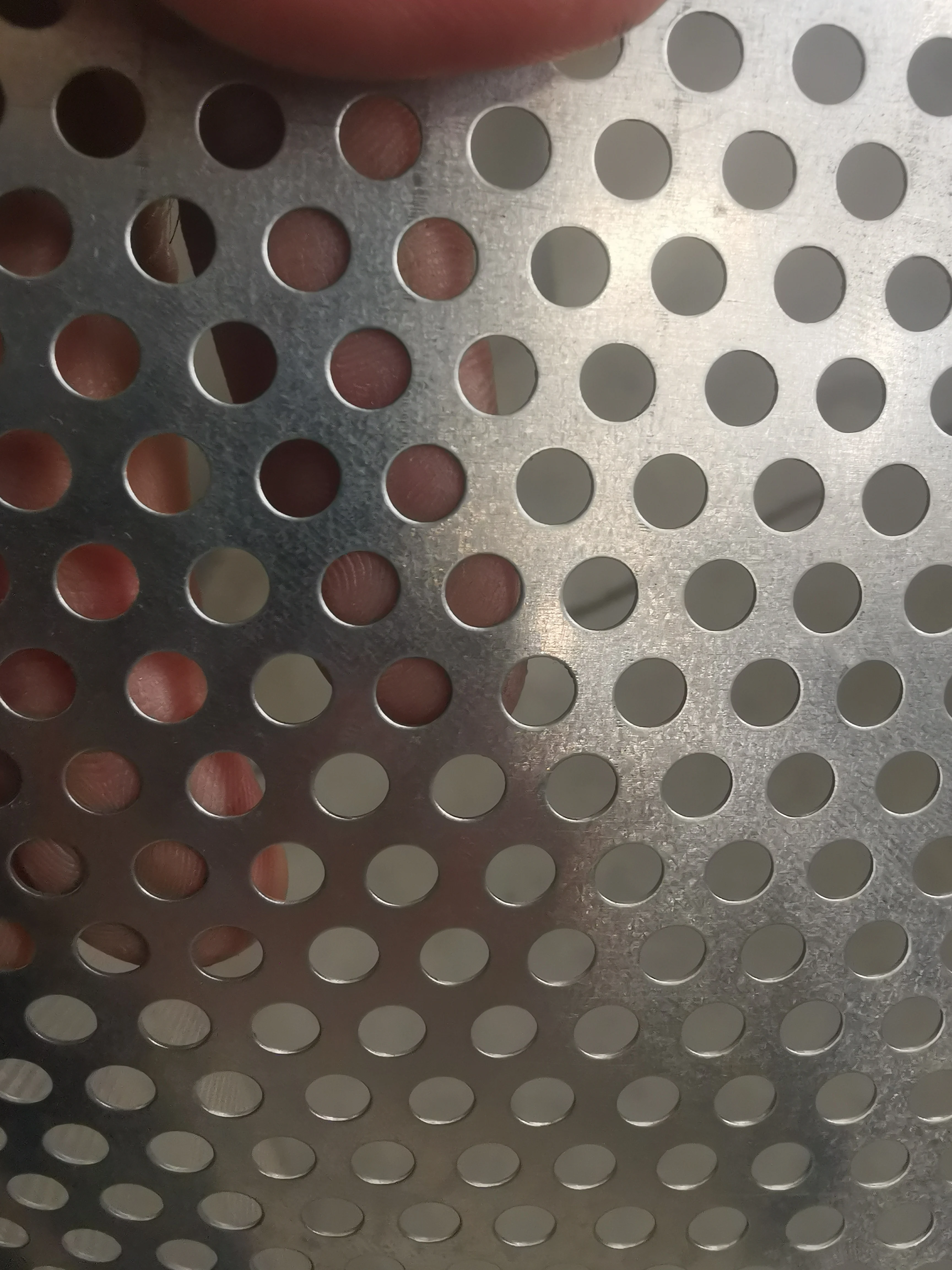 Perforated mesh for filter supporting mesh