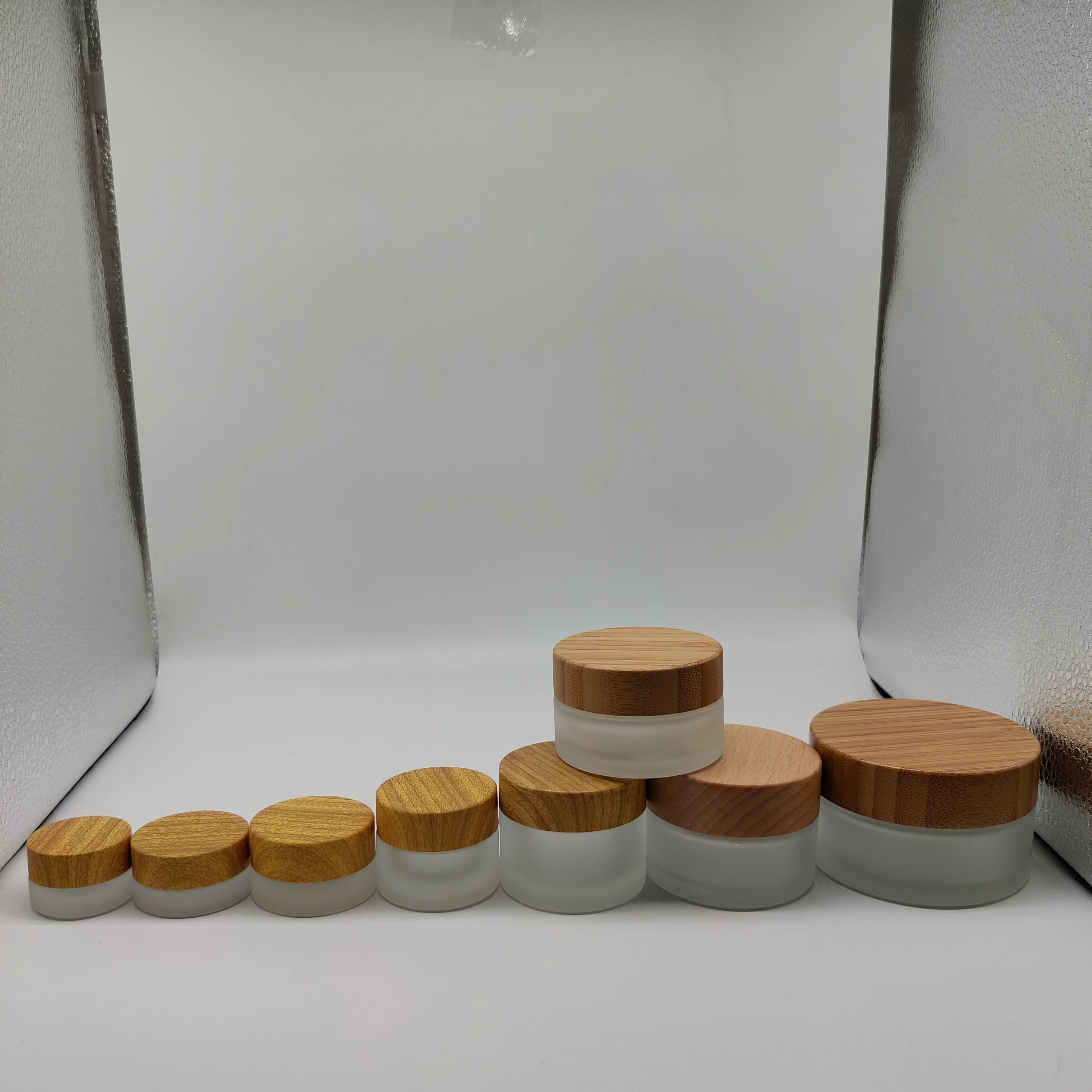 Factory hot sell cosmetic packaging 50ml frosted clear glass jar with bamboo lid