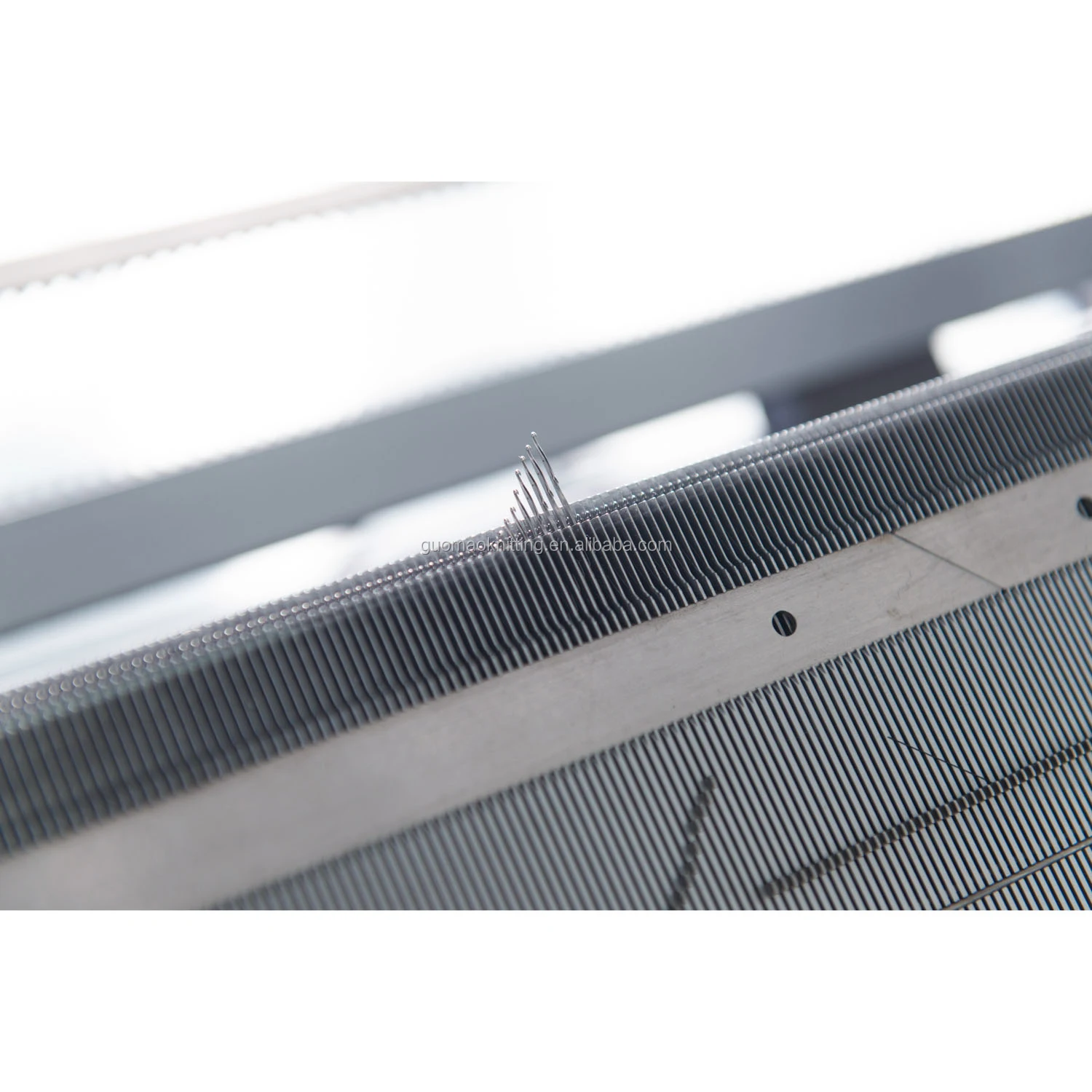 Economical single system computerized flat knitting machine