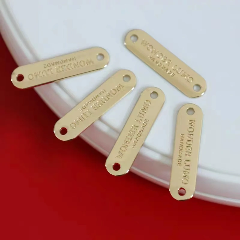Brand logo sewing hole metal tag on waistband
