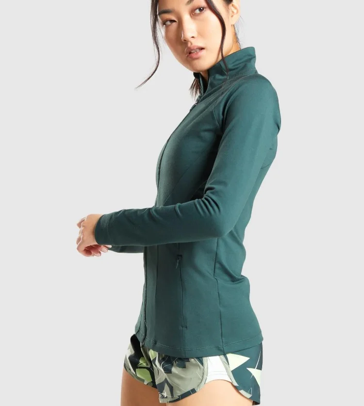 body fit nylon and spandex long sleeve high neck deep zipped pockets zip up ladies training sports athletic jacket women