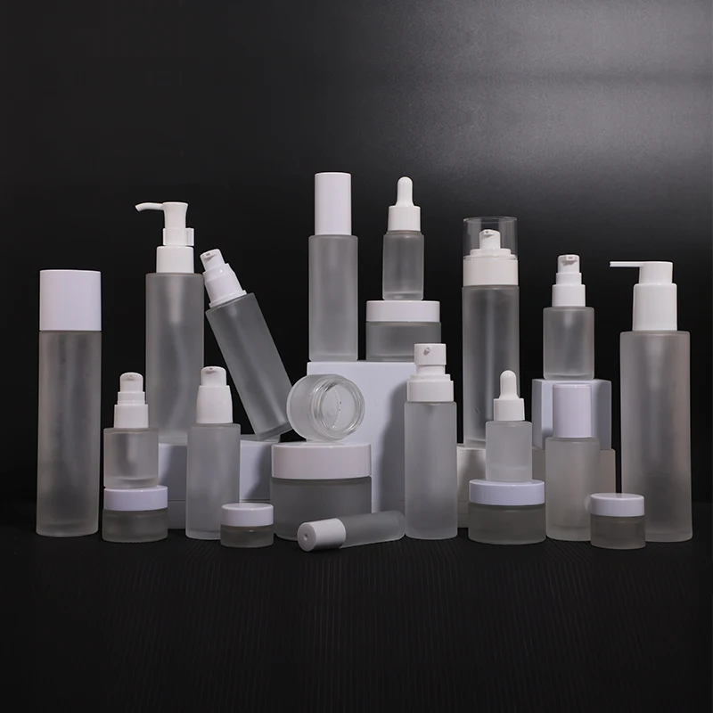 Wholesale empty frosted clear glass bottle with lotion spray pump for cosmetic packaging skincare cream container