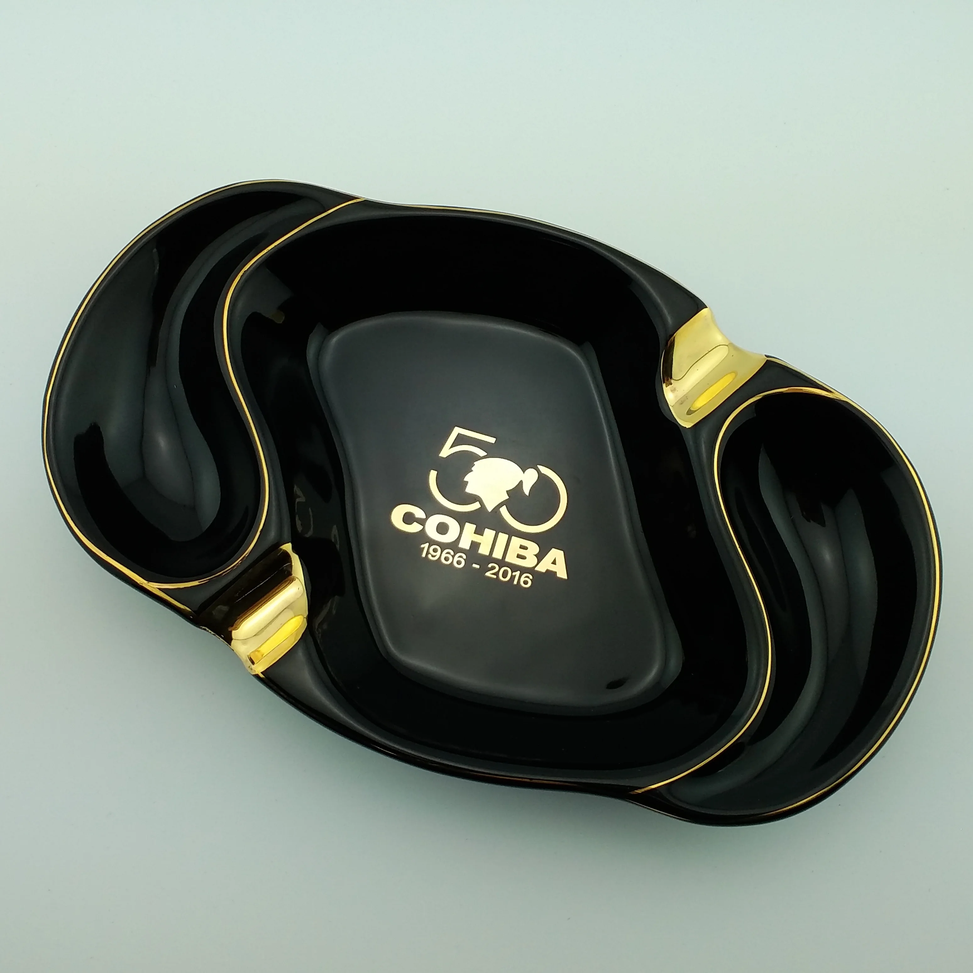 
Best selling oval ceramic ashtray with golden edge with two golden rest with customized logo for sale 