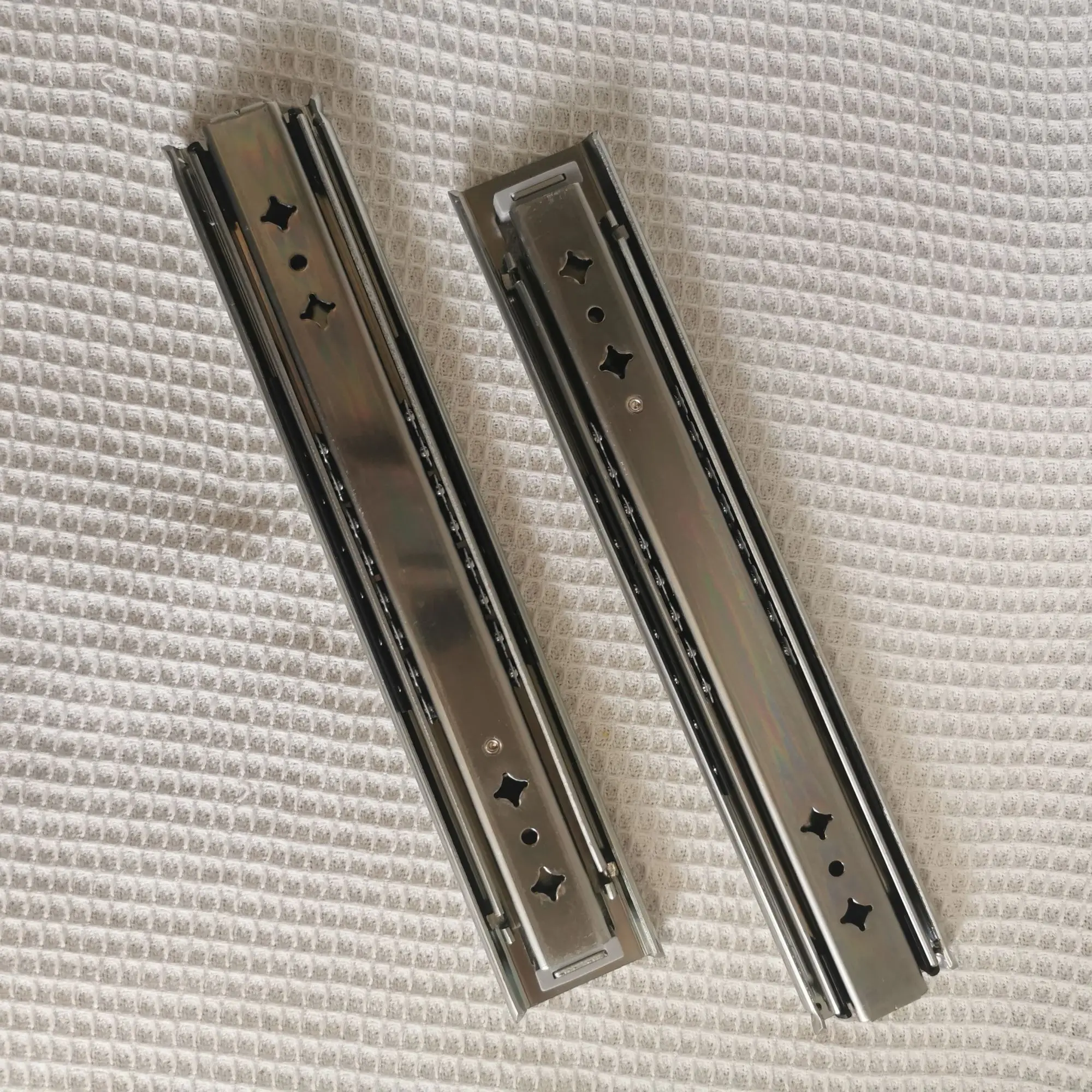 Hidden drawer slides are installed at the bottom of the heavy-duty drawer rails under the stairs