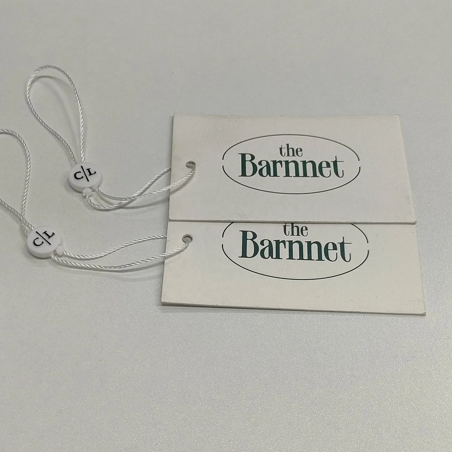 Customized luxury clothing tags clothing labels with printed name logo plastic tags with rope paper tags backpacks own logo
