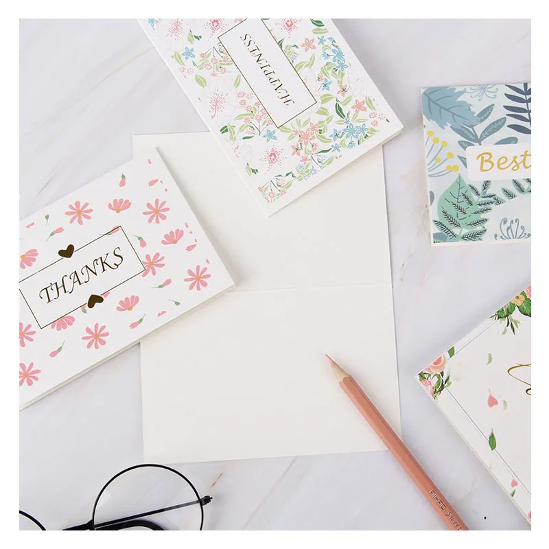 Customized flower thank-you cards with wild flowers, accompanied by envelopes. Floral blank greeting cards