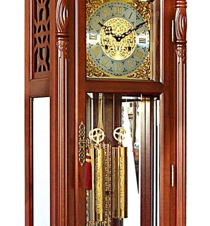 Polished-brass pendulum mirrors the dial polished brass weight shells with decorative bands Grandfather Clock