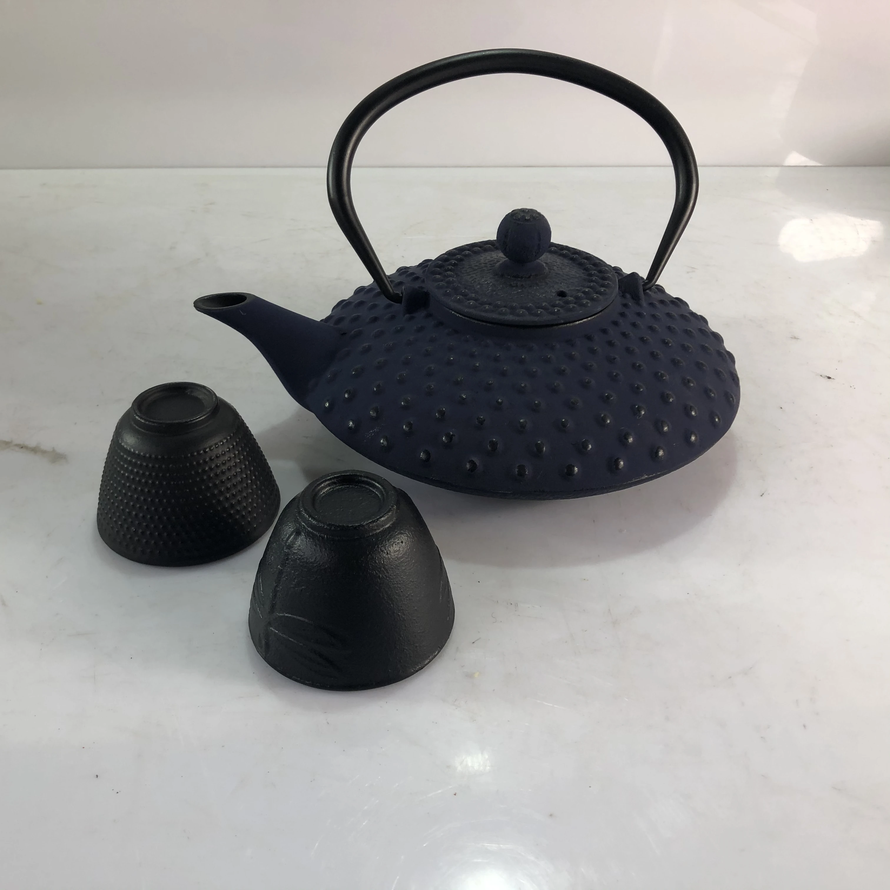 Cast iron teapot with cup