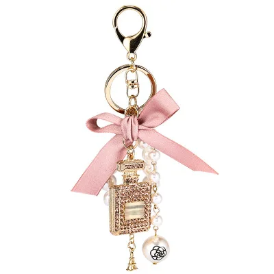 Factory hot sell diamond perfume bottle alloy keychain bowknot pearl pendant