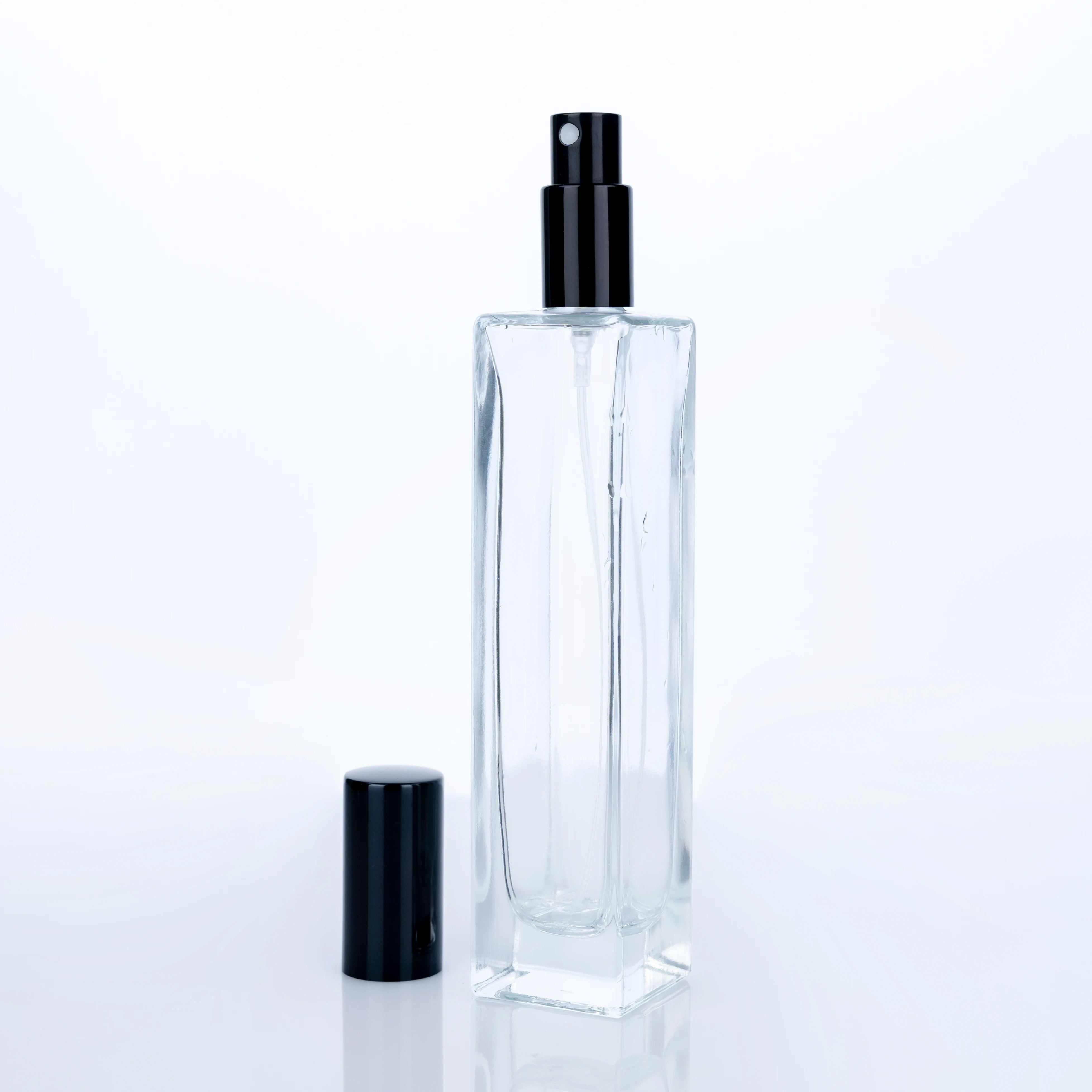 
The Customized High Quality 100ml Transparent Bottle With Black Round Cap Square Tall Perfume Bottle 