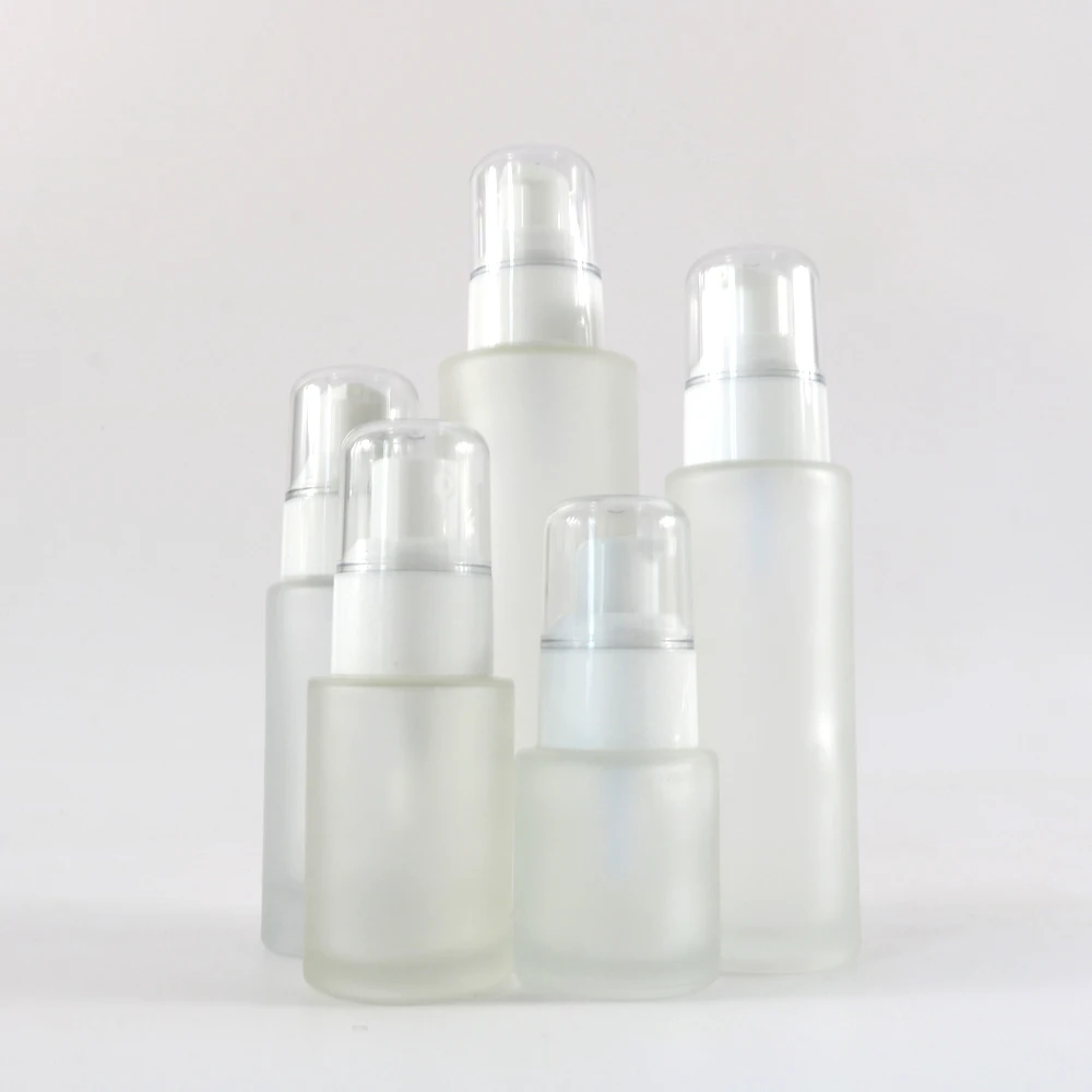 Cosmetic clear frosted glass flat shoulder bottle with white white pump