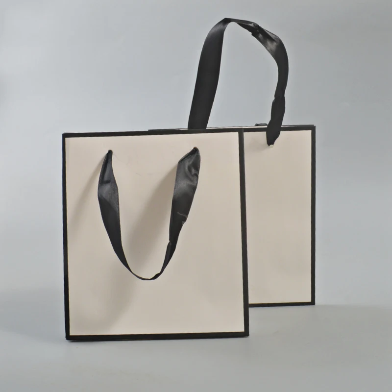 luxury cosmetic white paper gift bag with black handle paper garment bag supplies china