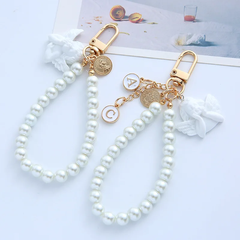 Factory Direct Price  Aesthetic Angel Keychain With Pearl Bead Wrist Baroque Airpods Pendant Bag Keychains For Women Girl