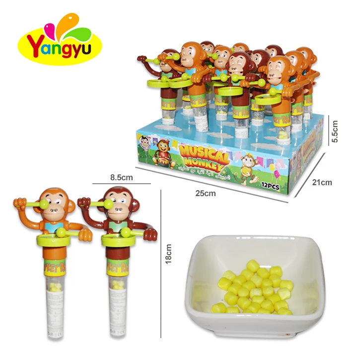 Plastic monkey playing drum toy with candy