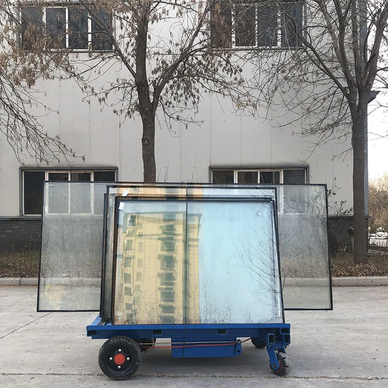 Chinese factory workers transport glass trucks electric trolley fitted with glass