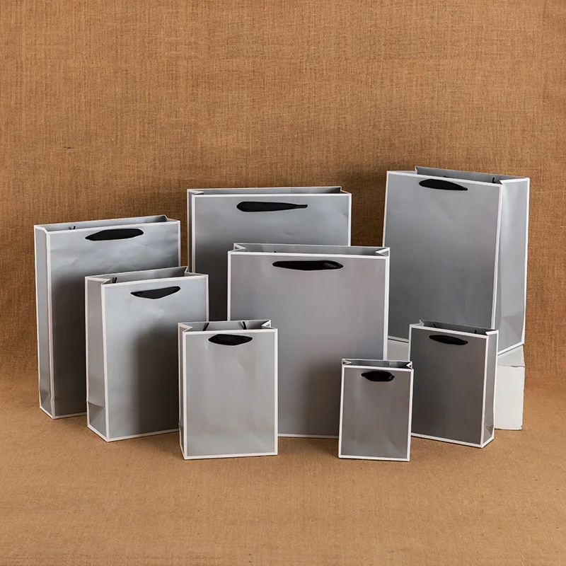 Wholesale custom printed grey and white cardboard stock gift clothing shopping paper bag with your own ribbon handle logo