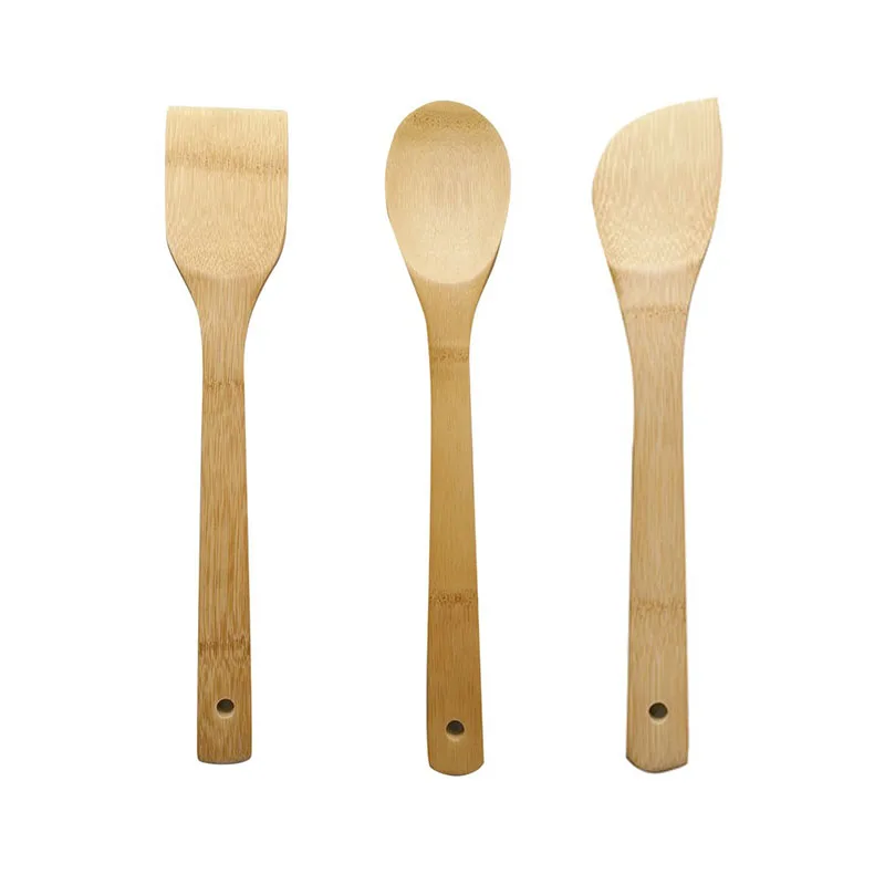 Bamboo spatula in stocked kitchen gadgets for cooking