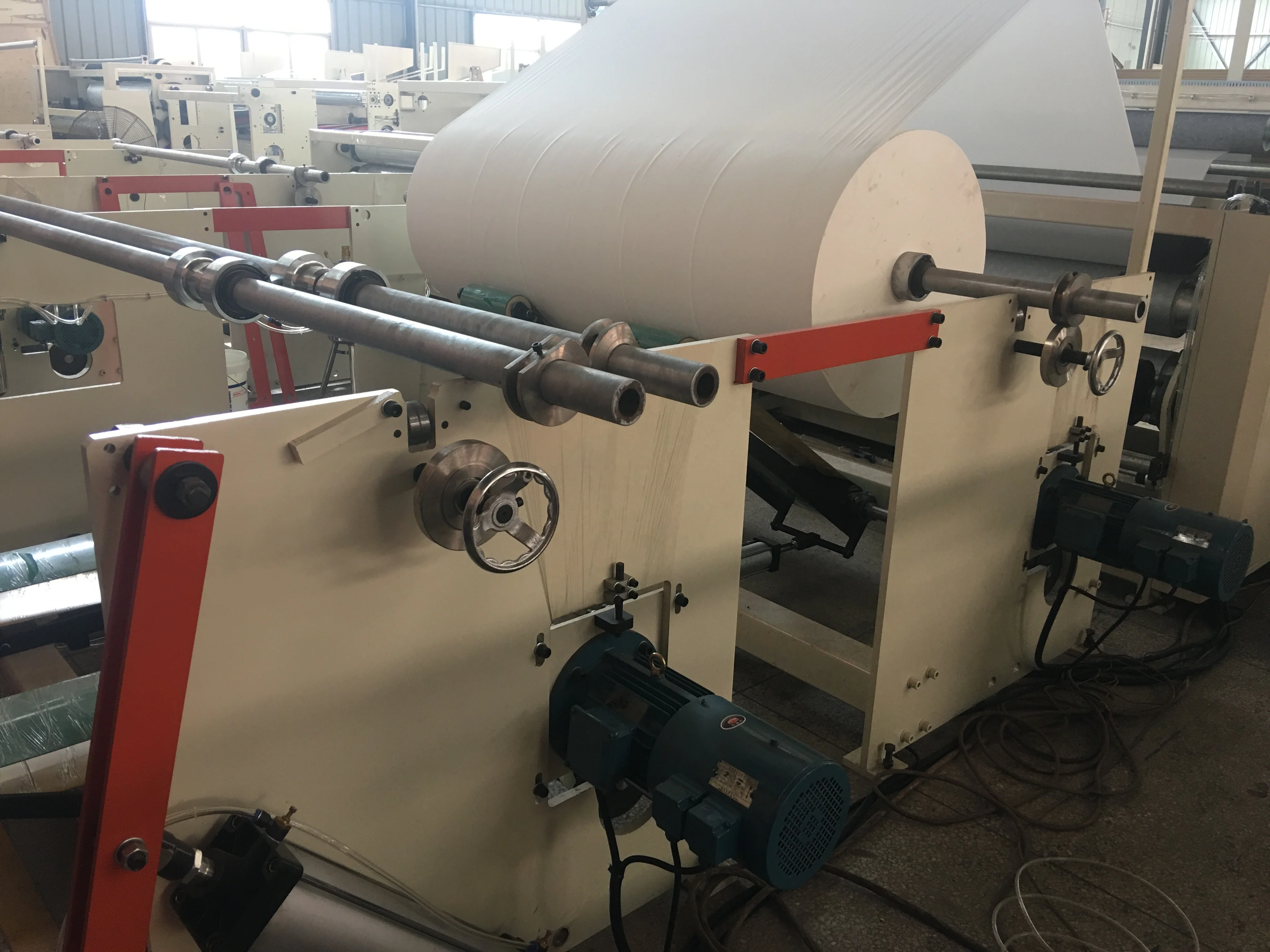 Automatic high speed rewinding embossing toilet tissue roll paper machine