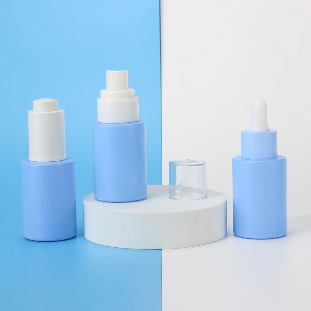 Wholesale 1oz empty blue round skin care glass bottle packaging cosmetic body oil bottle lotion bottle with pump cap 30ml