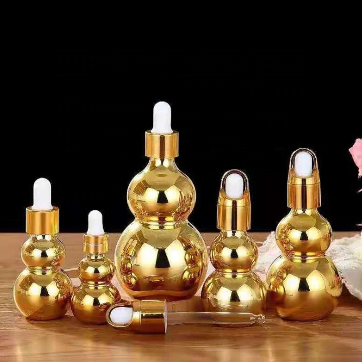 special round cute mini gold shiny 30ml 15ml 50ml ess oil body face glass serum bottle with pink custom dropper pipette bulb