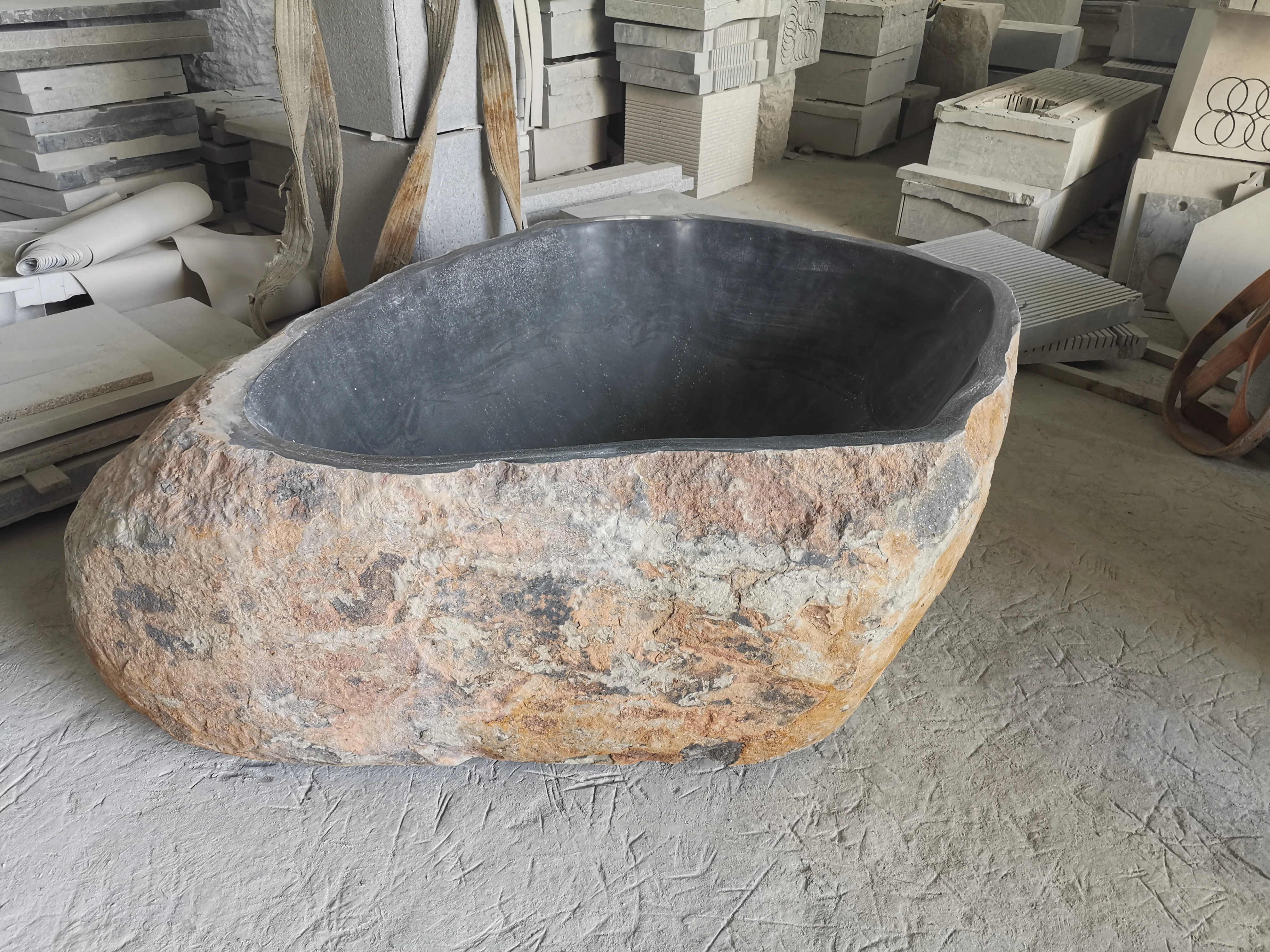 Free standing natural river stone bathtub