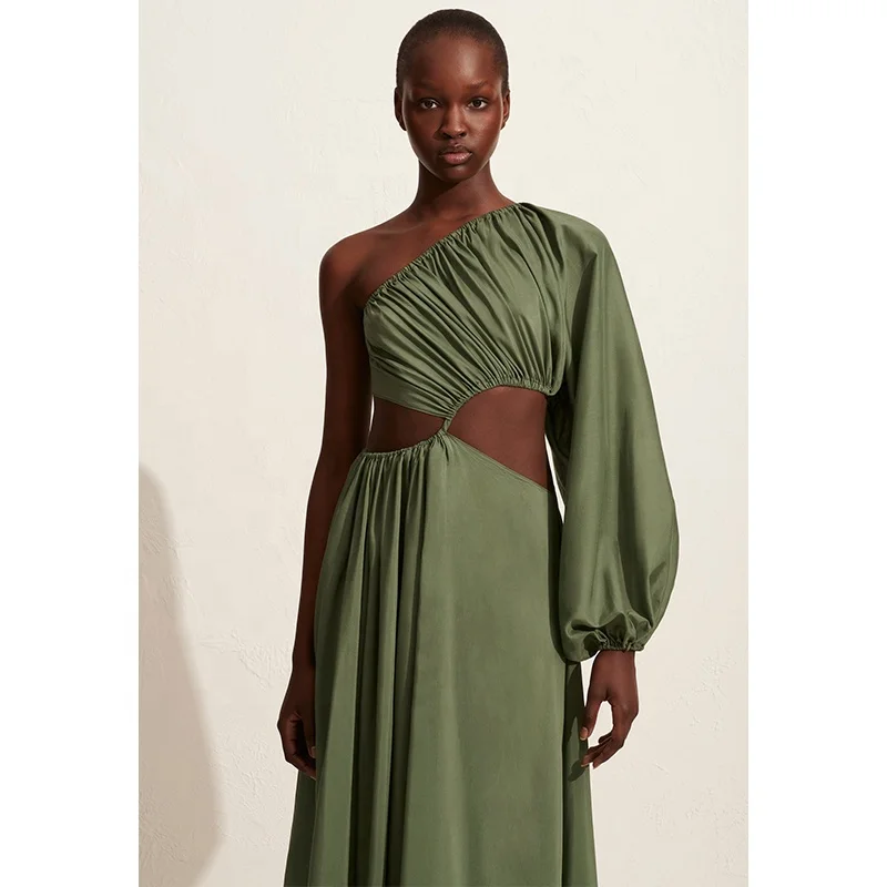 Women asymmetric full-length dress with bold waist cut-outs and a single voluminous long sleeve organic cotton maxi dress