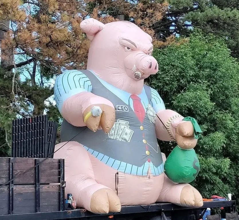 Giant Inflatable cat with construction worker and money bag in hands Inflatable Fat Cat Chokes Union Workers