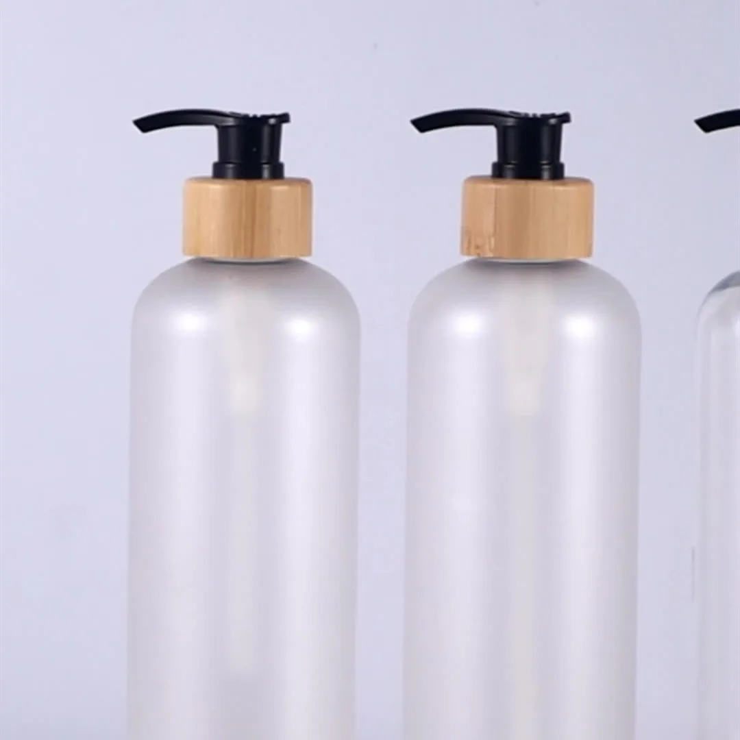Free Sample Reusable 250ml 300ml Round Shoulder Bamboo Wood Pressed Emulsion Bottle for Cosmetic Packaging Frosted PET Bottle