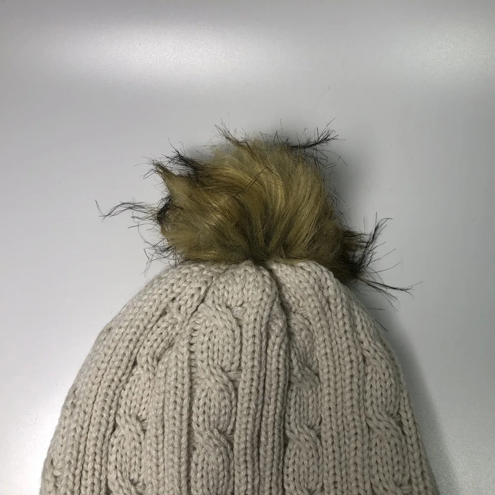 Women fashion beige faux fur pom pom skull bobble hats for children and adults Custom embroidery label acrylic cable knit beanie
