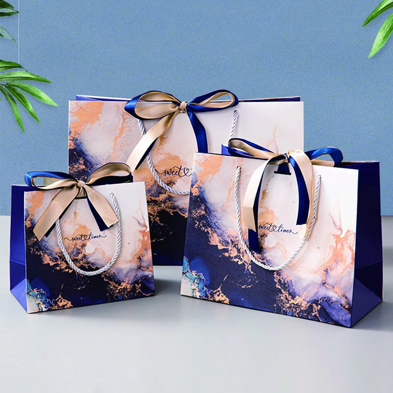 Wholesale Luxury Bulk Square Bottom White Cardboard Offset Printing Clothing Jewelry Paper Gift Bags with Ribbon Bow and Handles
