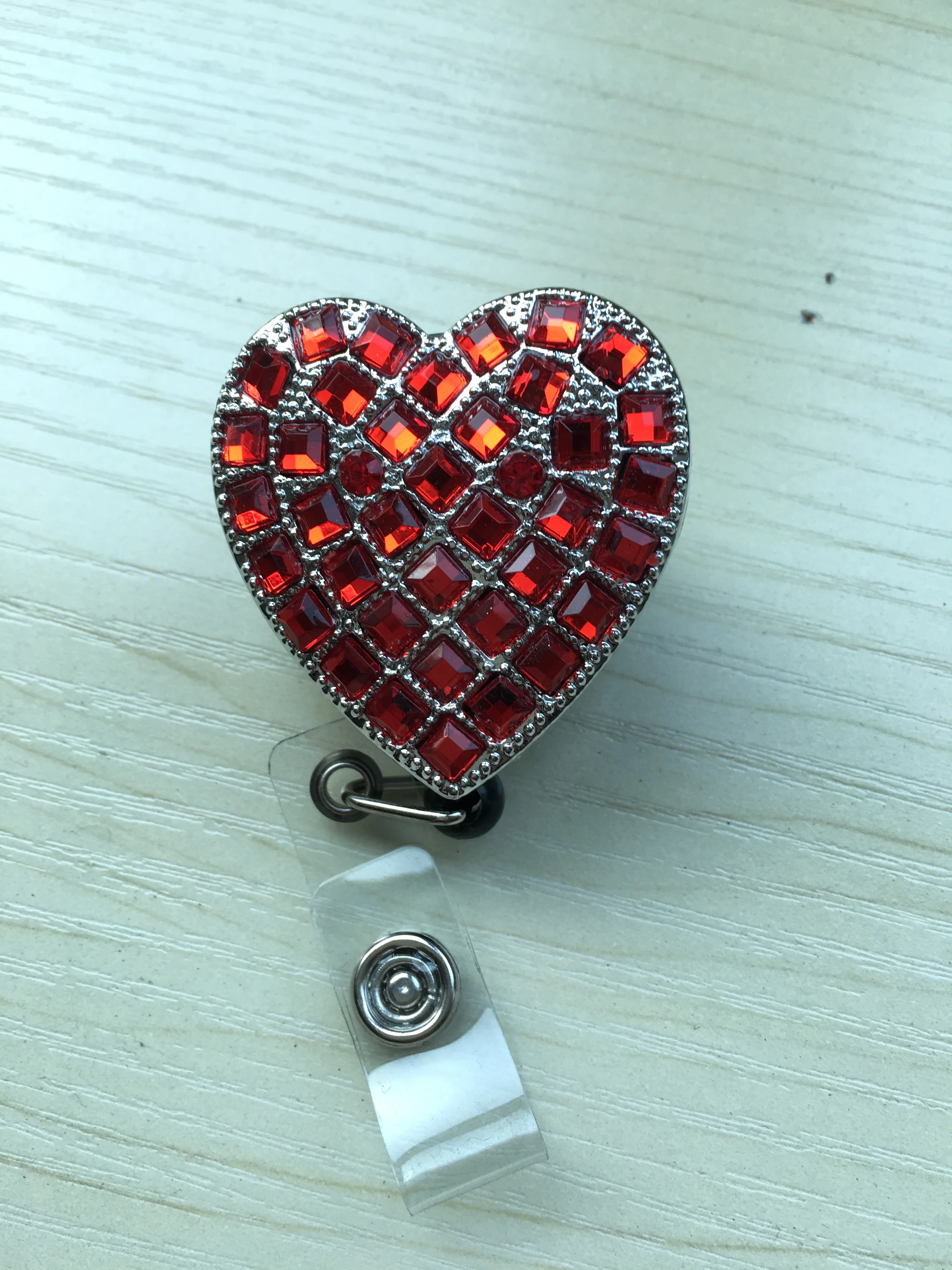 Retractable reel badge with breast cancer awareness logo