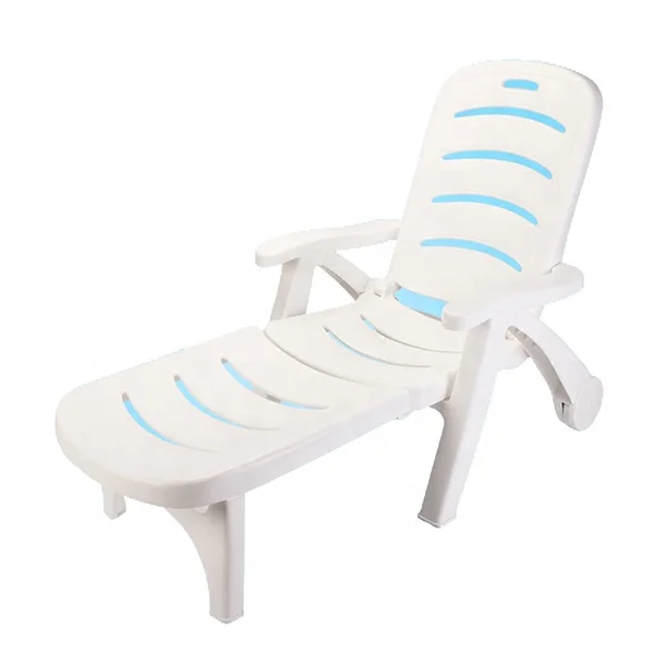 Outdoor beach hotel swimming pool plastic chaise lounge chair