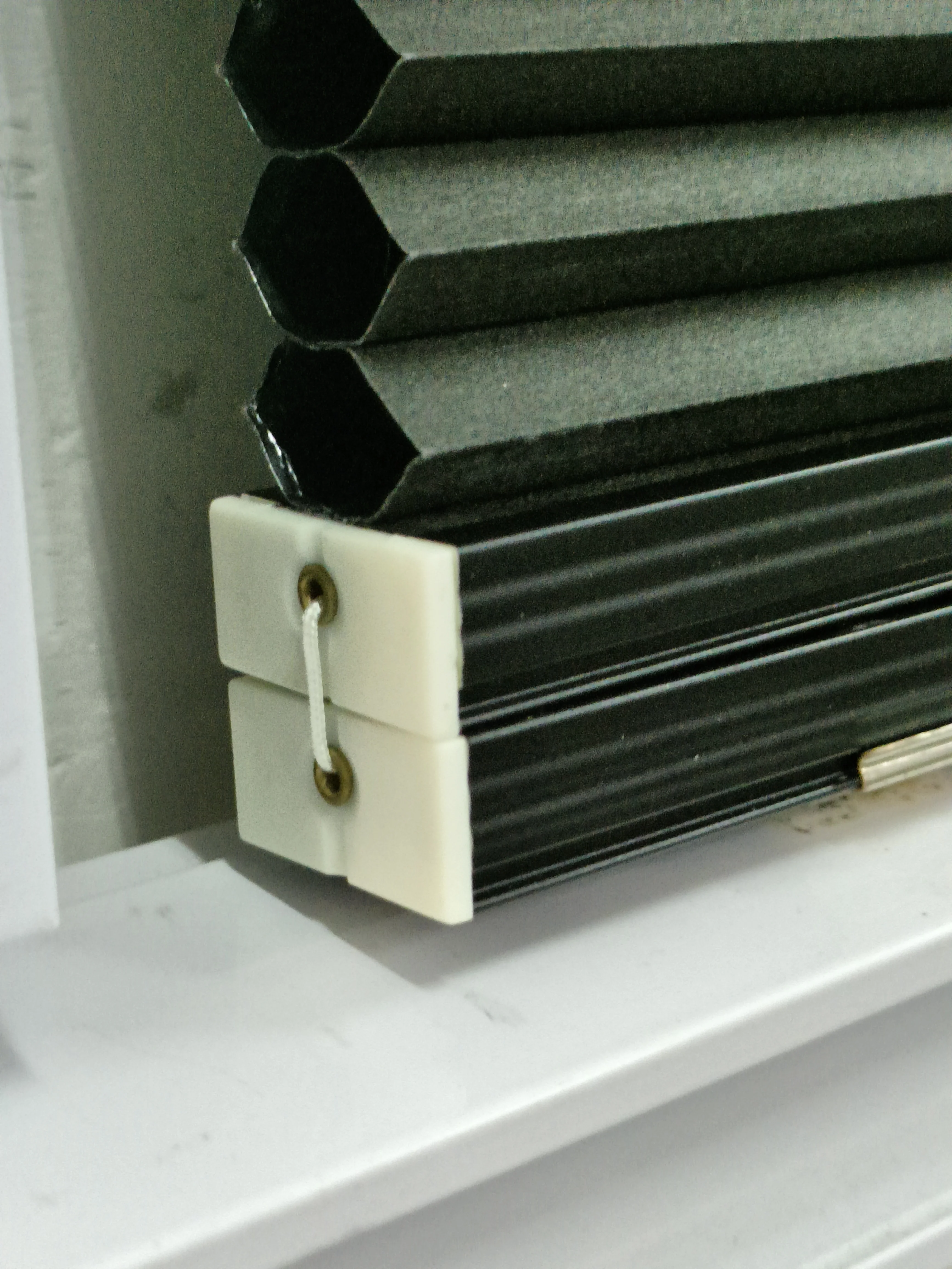 Cordless black color blackout cellular blind