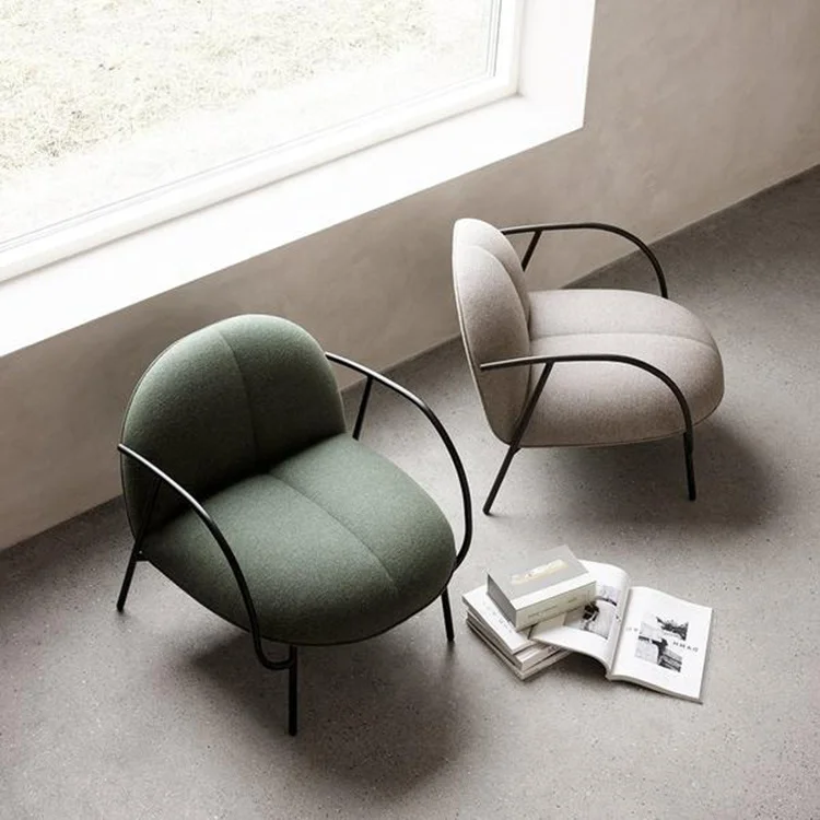 Modern round arm-rest  Low easy chair with leg in matte black steel Upholstery available in leather or fabric