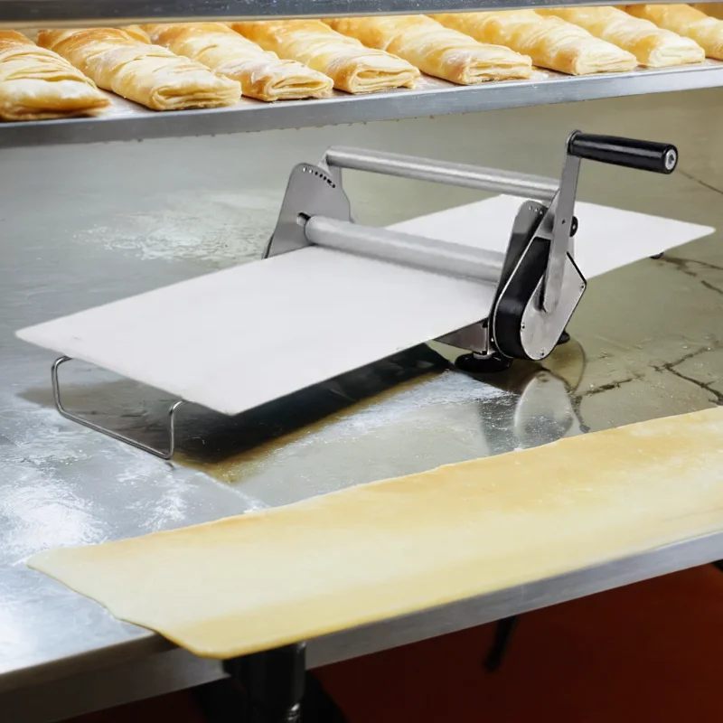 A Mini pastry portable small table top hand manual pizza dough sheeter roller shelter press flattener shetter laminator machine