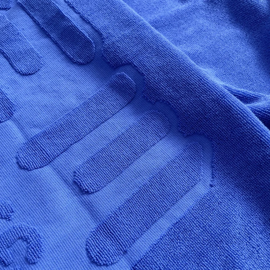 Embossed cotton beach towel with jacquard logo