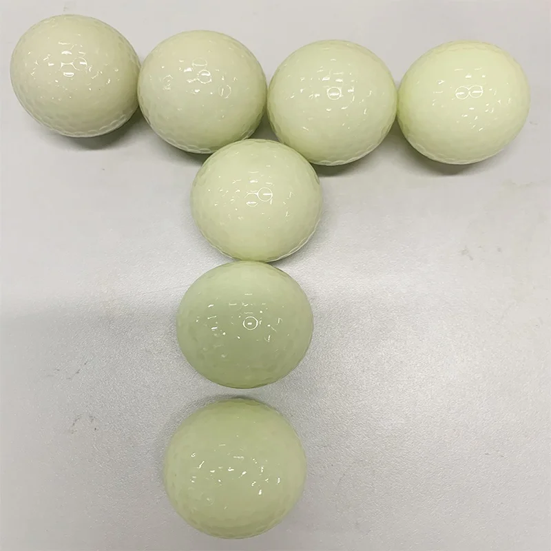 white fluorescent golf ball in golf  balls