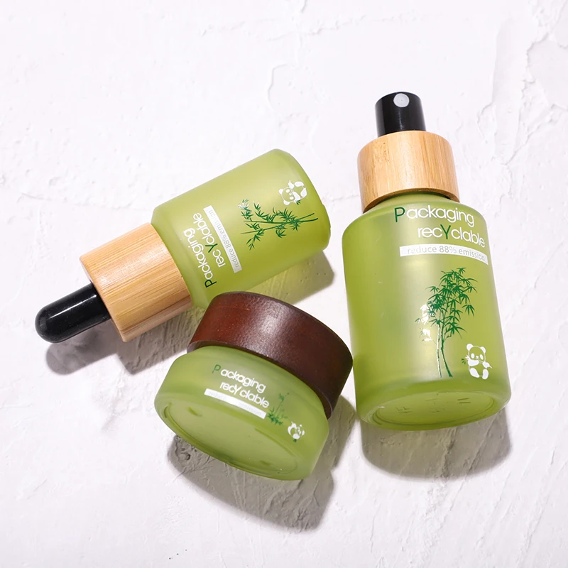 Fancy label frosted green glass bottle jar for face scream skin care lotion products with bamboo wooden lid bottle manufacturing