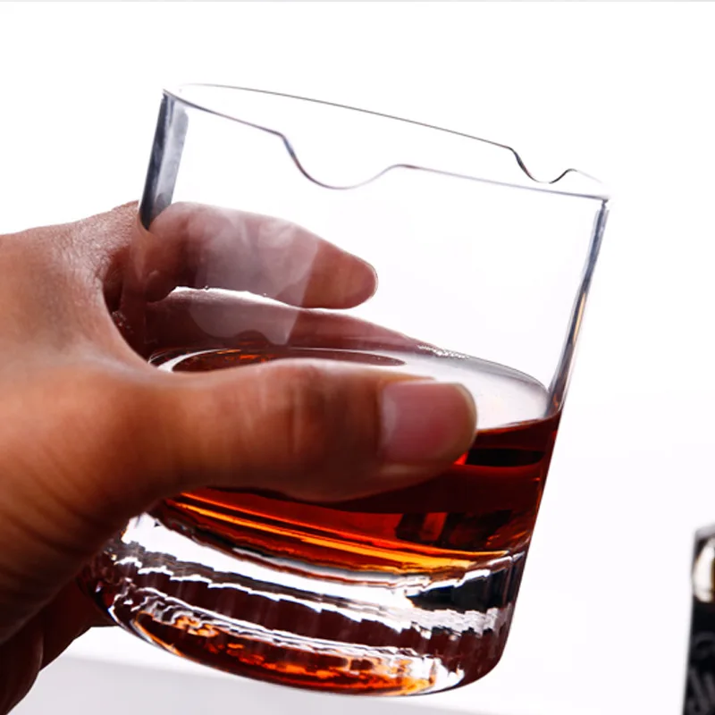 Cigar holding whiskey glass