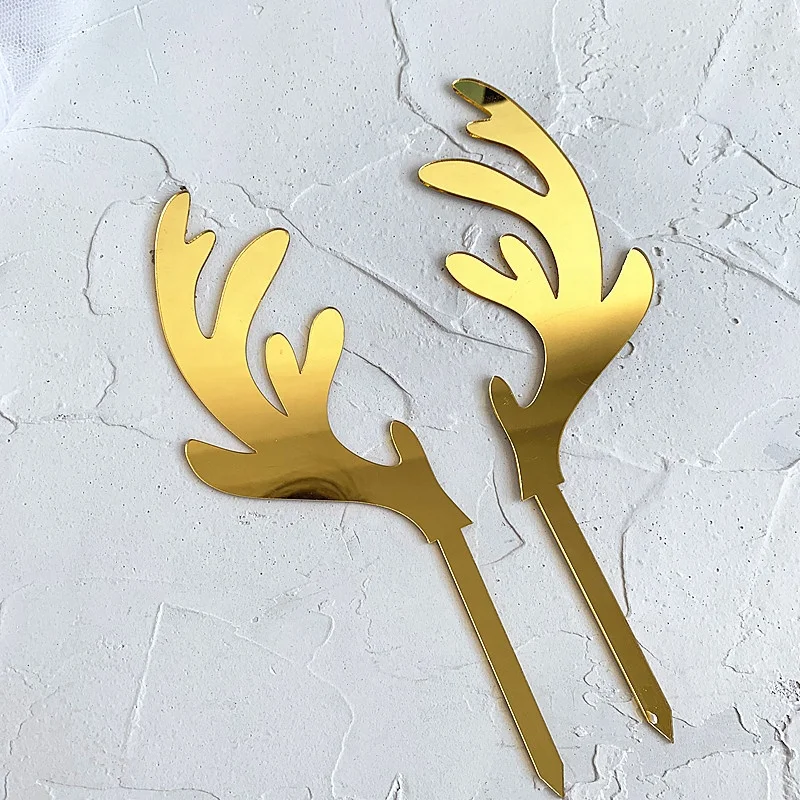 A pair of gold elk acrylic Christmas cake topper for cake decoration