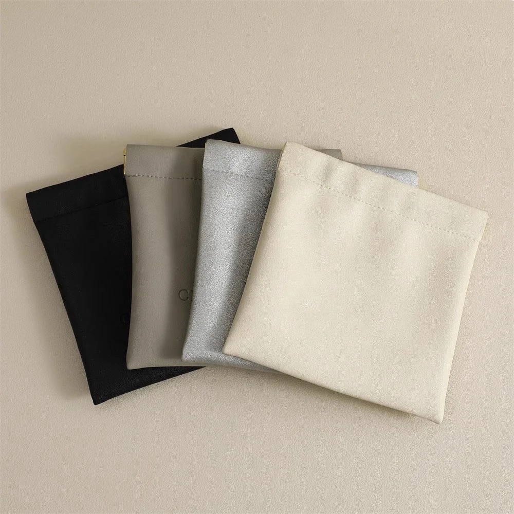 Custom Emboss Printing Squeeze Pu Leather Bag For Coin Jewelry Storage Closing Magnet Leather Jewelry Pouch