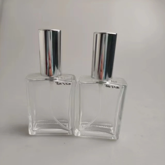 100ml perfume spray bottles cosmetic glass container transparent body and silver lid