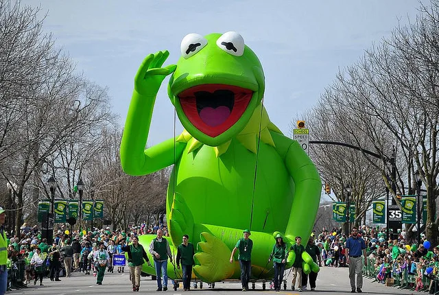 Printed 7m high 14 m long giant inflatable football player helium balloon in a kicking pose for parades